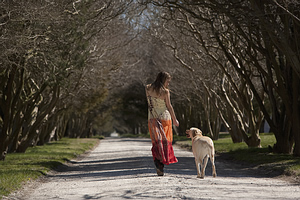 The results of leash training a dog: See how her dog stays by her side during a walk.